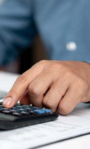 Hand and calculator